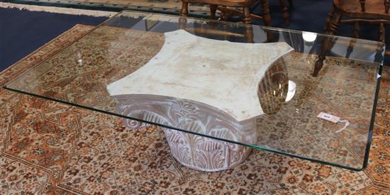 A plate glass coffee table on composition capital base, 140cm wide